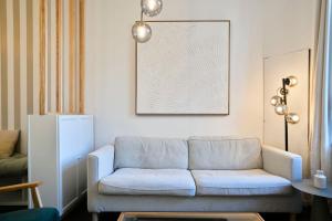 a living room with a couch and a table at Renovated 3 bedroom house with terrace in Tourcoing