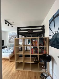 a bedroom with a bunk bed and a book shelf at Mini Loft Apartment in Garmisch-Partenkirchen