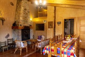 a dining room with a table and chairs and a fireplace at Casa Rural Islas Galápagos in Berlanga de Duero