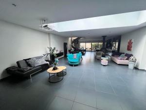 a large living room with couches and a table at Le Loly in Clermont-Ferrand