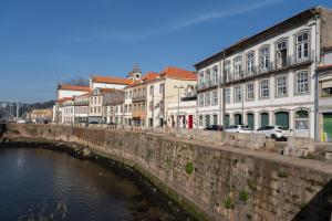 a group of buildings next to a river at Apartamento Premium Douro River Views in Porto