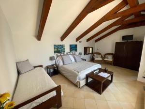 a large bedroom with a bed and a table at L'Eco dell'800 in Furore