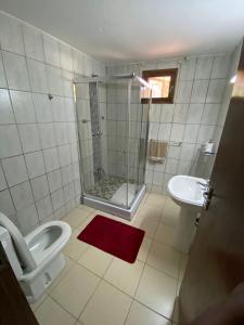 a bathroom with a shower and a toilet and a sink at Vacation Home close to the beach in Bilene in Vila Praia Do Bilene