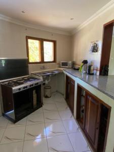 a kitchen with a stove and a counter top at Vacation Home close to the beach in Bilene in Vila Praia Do Bilene