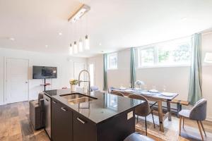 a kitchen with a table and a dining room at Free Parking - Best Travel by Zen Living in Longueuil