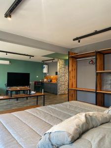a bedroom with a bed and a flat screen tv at Departamento Campana Centro in Campana