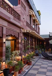 a building with potted plants on a patio at Dream Connect Boutique House in Jodhpur