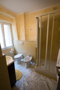 a bathroom with a shower and a toilet and a sink at Foresteria Del Pescatore in La Spezia