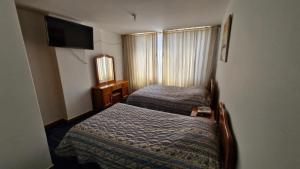 pokój hotelowy z 2 łóżkami i telewizorem w obiekcie Hotel Catalina Real w mieście Duitama