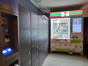 a room with a refrigerator and lockers in a store at 1 Bed Room Near Saphanmai BTS, Don Mueang Airport in Ban Ko