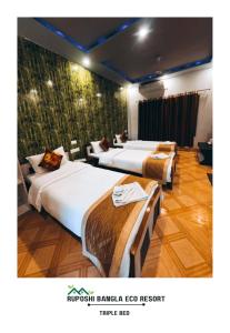 מיטה או מיטות בחדר ב-Vip's Ruposhi Bangla Eco Resort