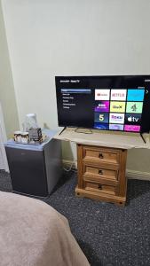 a computer monitor sitting on top of a wooden desk at Affordable Private Space in Leeds