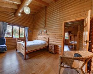 a bedroom with a bed in a log cabin at Pinecroft Lodges in Ingleton 