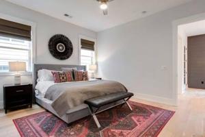 a white bedroom with a bed and a rug at The Blair - Sunny Elegance, West End Luxury in Nashville