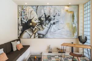 a living room with a large painting on the wall at Enigma Bali Villas Complex Canggu in Canggu