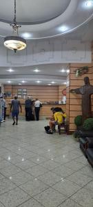 a group of people in a lobby with a statue at Itajubá Hotel in Rio de Janeiro