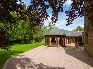 a gazebo in the yard of a house at Heads Nook Hall Cottage in Carlisle
