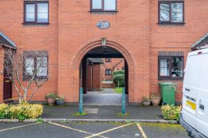 an entrance to a brick building with a clock at Modern studio flat in Wellington, Telford in Wellington +1 photo