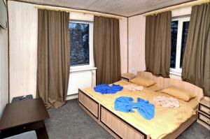 a bedroom with a large bed with blue towels on it at Готель Міленіум in Dragobrat