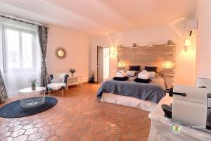 a large bedroom with a bed and a window at La bastide Maë in Saint-Remèze