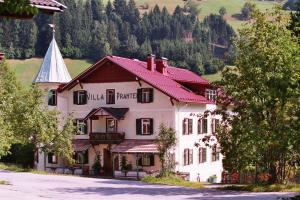 a large white building with a red roof at Villa Pranter in Sillian