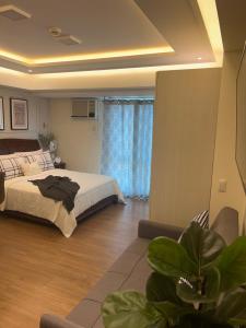 Ένα ή περισσότερα κρεβάτια σε δωμάτιο στο Condotel in Abreeza Ayala Mall +33 φωτογραφίες