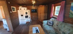 a living room with a couch and a stove at Talblickhütte in Rauris