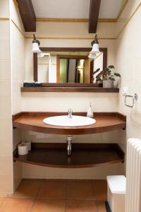 a bathroom with a sink and a mirror at Apartamentos Turisticos A Estacion in A Pontenova