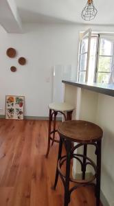 a room with a table and two stools in it at Les Vitraux de Saint Rémi in Dieppe
