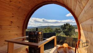 an arched window in a wooden cabin with a view at La pépite d'amour in Sainte-Anastasie-sur-Issole