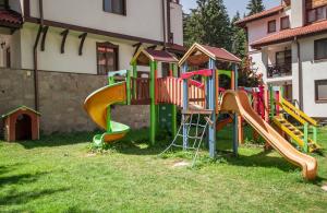 a playground with a slide in a yard at Lake View Apartment in Pamporovo