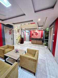 a lobby of a building with couches and a table at Hotel Wedlock 39 in Gurgaon