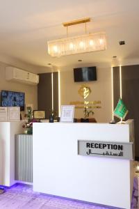a reception counter in a room with a light at جوهرة دومة الجندل للشقق المخدومة Jawharat Dumat Serviced Apartments in Dawmat al Jandal