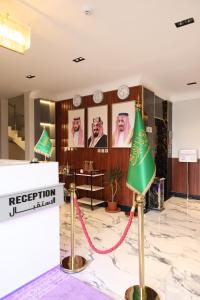 a reception room with a green lamp on a marble floor at جوهرة دومة الجندل للشقق المخدومة Jawharat Dumat Serviced Apartments in Dawmat al Jandal