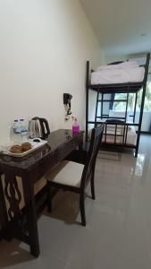 a desk and a chair in a room with bunk beds at Khao Sok Family Room House in Khao Sok National Park