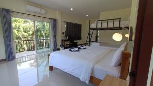 a bedroom with a bed and a large window at Khao Sok Family Room House in Khao Sok National Park