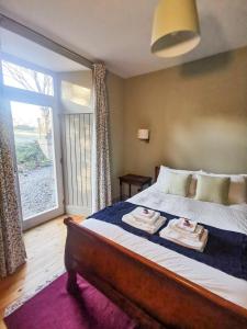 a bedroom with a bed with two towels on it at Jameswood Villa in Sandbank