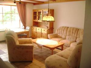 a living room with two couches and a table at Ferienwohnung Enzian 2 im Feriendorf Sonnenhang im Allgäu in Missen-Wilhams
