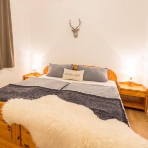 a bedroom with a bed with a rug on it at Ferienwohnung Enzian 4 im Feriendorf Sonnenhang im Allgäu in Missen-Wilhams