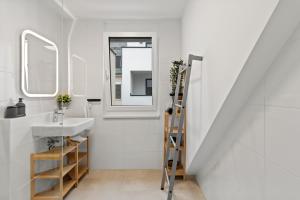 a bathroom with a sink and a mirror at Modern Haven - Near Klinik Floridsdorf in Vienna