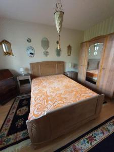 a bedroom with a large bed with an orange bedspread at Appartement dans un jardin in Geneva