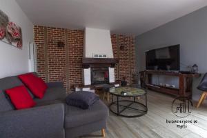 a living room with a couch and a fireplace at L'Escapade Albigeoise in Albi +25 photos