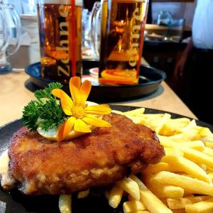a plate of food with a chicken and french fries at Landgasthof Zehner in Drosendorf
