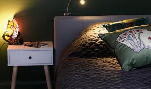 a bedroom with a bed with a night stand with a lamp at Wonderland21 in Saint-Germain-sur-Morin