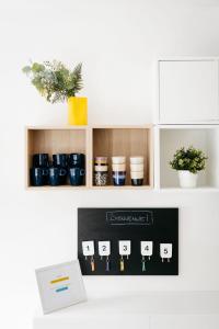 a shelf with cups and plants on it at Le Gîtel in Spa