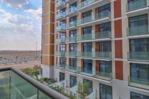 a tall building with balconies next to a beach at Affordable Living near Dubai Al Makhtom Airport - Ezytrac Vacation Homes in Dubai