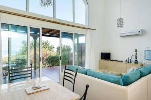 Saint AmvrosiosにあるJoya Cyprus Sapphire Garden Apartmentのリビングルーム(テーブル、ソファ付)