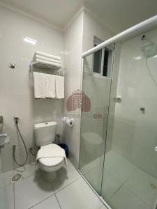 uma casa de banho branca com um WC e um chuveiro em Spazzio diRoma com acesso ao Acqua Park - Gualberto em Caldas Novas