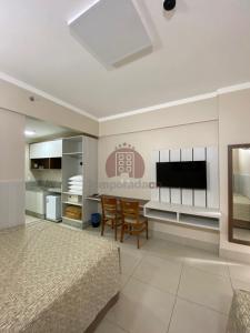 a bedroom with a bed and a flat screen tv at Spazzio diRoma com acesso ao Acqua Park - Gualberto in Caldas Novas