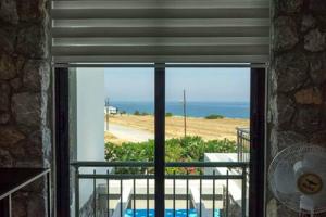 a window of a room with a view of the ocean at Joya Cypern Seaside Luxurious Villa and Private Pool in Akanthou